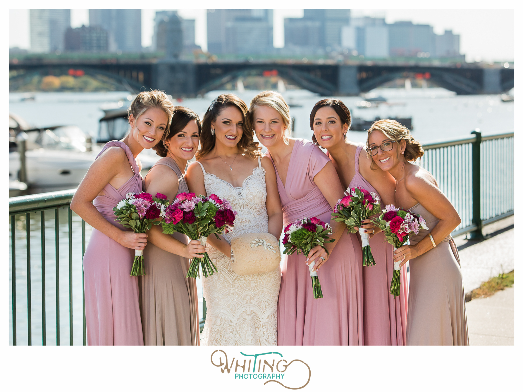 Bridesmaids in pink along Charles River with Boston skyline at Royal Sonesta