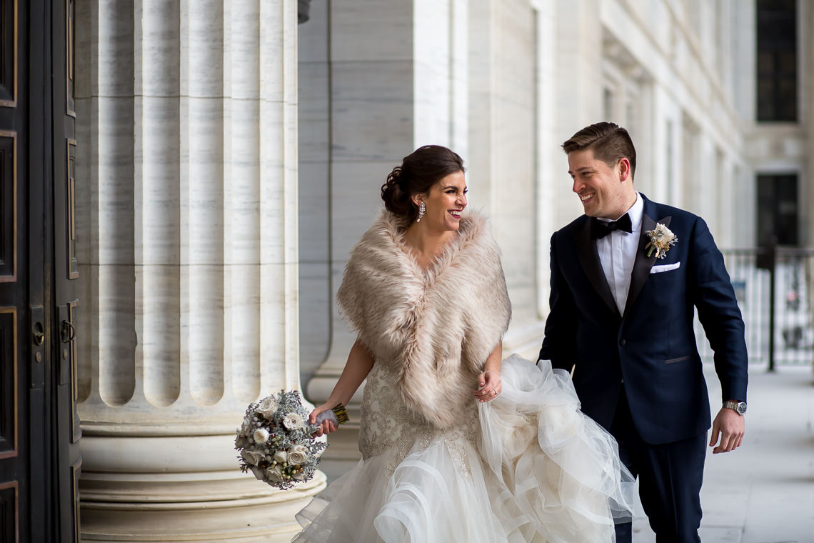 bride and groom in front of Albany education building, winter wedding