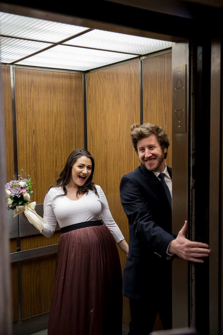 bride and groom on elevator at boston city hall