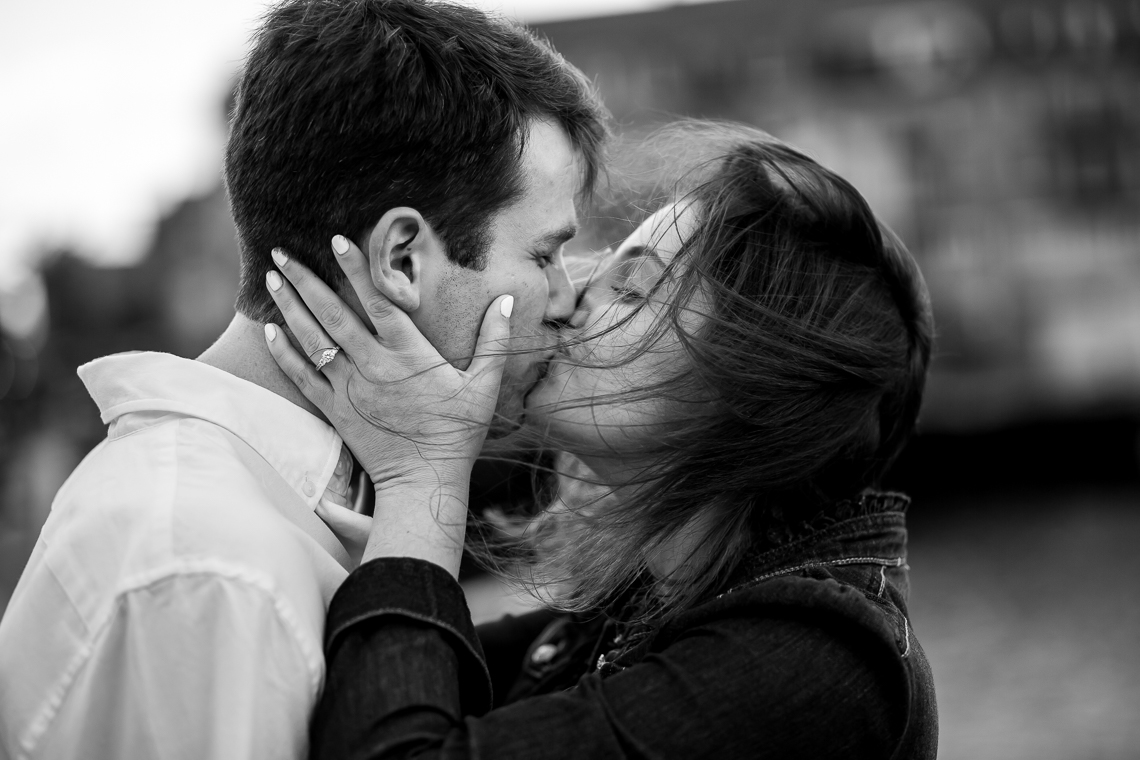 black and white windy engagement photo on Boston waterfront